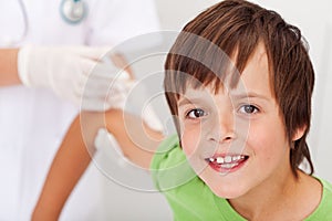 Happy boy receiving vaccine or injection