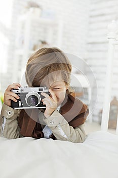 Happy boy with retro camera