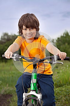 Happy boy ride bikes outdoors