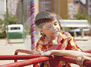 Happy boy riding on a spinning swing