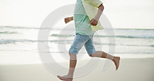 Happy, boy and run on beach for fun on summer vacation with freedom to explore in Thailand for childhood joy. Child