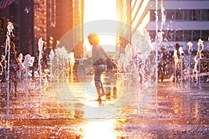 Happy boy run on fountain water Philadelphia city photo