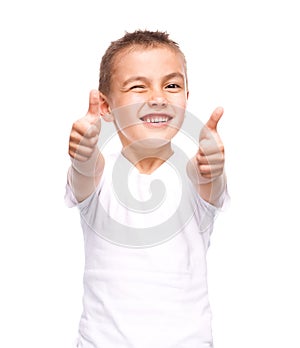 Happy boy is showing thumb up gesture