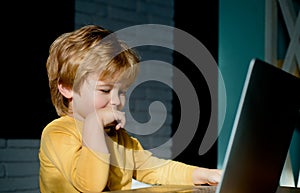 Happy boy sitting With laptop computer. Chatting, correspondence. Online communication. Virtual friends. Internet