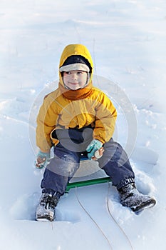 Happy boy on sled