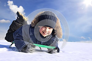 Happy boy on sled