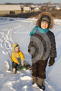 Happy boy with sled