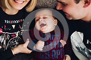 Happy boy smiling and playing together with parents.