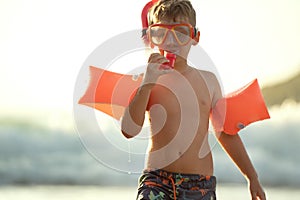 Happy boy snorkeling, vacation day. Summer sunny light. Happiness