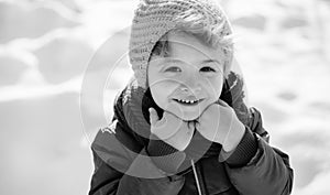 Happy boy on snow background. Winter child. Holidays Emotions.