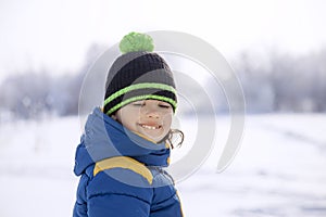 Happy boy in snow play and smile sunny day