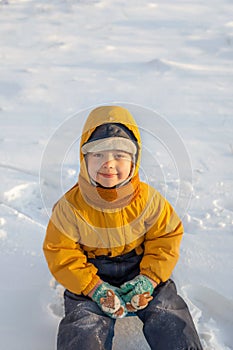 Happy boy in snow play and smile sunny day outdoors