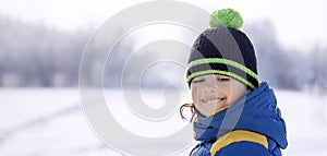 Happy boy in snow play and smile sunny day outdoors