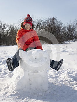 Happy boy in snow play and smile sunny day outdoors