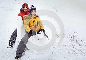 Happy boy in snow play and smile sunny day outdoors