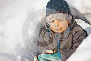 Happy boy in snow play and smile sunny day outdoors