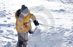 Happy boy in snow play and smile sunny day outdoors