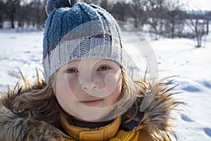 Happy boy in snow play and smile sunny day outdoors