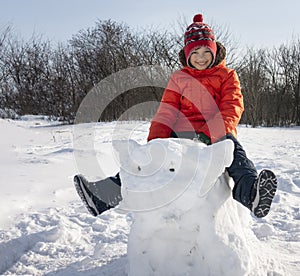 Happy boy in snow play and smile sunny day outdoors