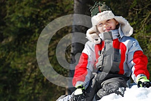 Happy boy on snowbank