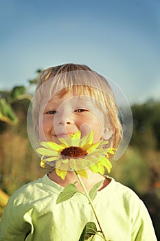 Happy boy with sunflower