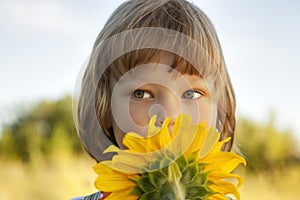 Happy boy with sunflower