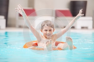 Happy boy swiming in pool photo