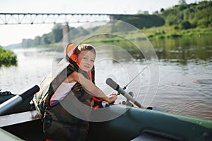 Happy boy swimming in fishing boat