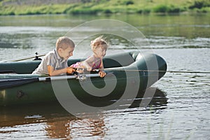 Happy boy swimming in fishing boat