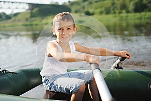 Happy boy swimming in fishing boat