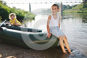 Happy boy swimming in fishing boat