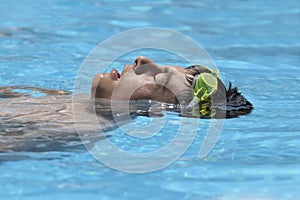 Happy boy swimming in the pool