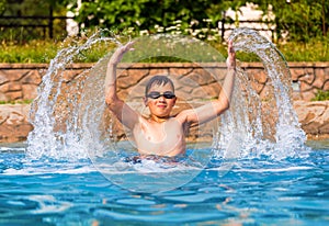 Happy boy in a swimming pool