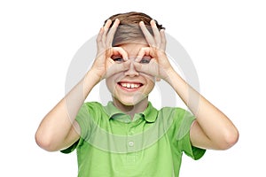 Happy boy in t-shirt having fun and making faces