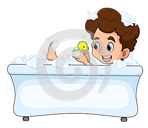 The happy boy is taking a bath in the bathtub and playing the duck rubber