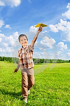 Happy boy throwing paper plane