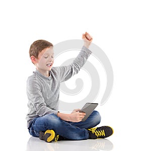 Happy boy using a tablet.