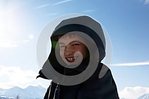 happy boy walking in sunny mountains children's clothing for the mountains close smiling portrait