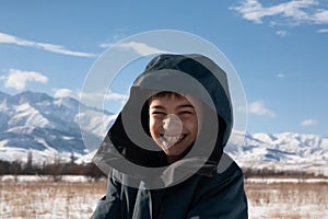 happy boy walking in sunny mountains children's clothing for the mountains close smiling portrait