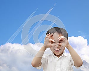 Happy boy watching airplane flying