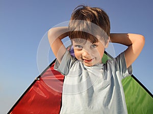 Happy boy with wings against sky dream of flying