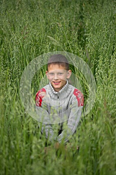 Happy boy young man on a green grain field