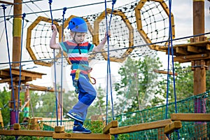 Happy boy on the zip line. proud of his courage the child in the