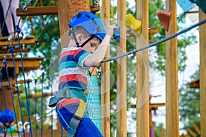 Happy boy on the zip line. proud of his courage the child in the