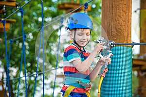 Happy boy on the zip line. proud of his courage the child in the