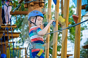 Happy boy on the zip line. proud of his courage the child in the