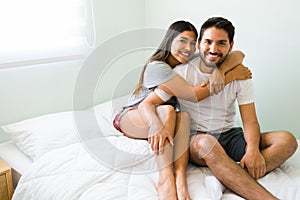 Happy boyfriend and girlfriend in the bedroom