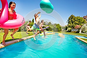 Happy boys and girls playing pool games outdoors