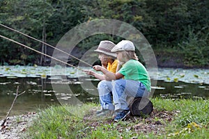 Happy boys go fishing on the river, Two children of the fisher w