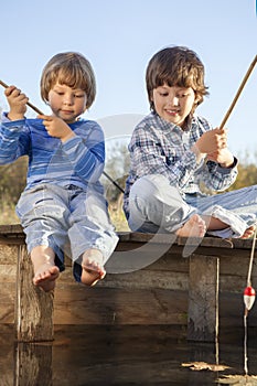 Happy boys go fishing on the river , Two children of fisherm